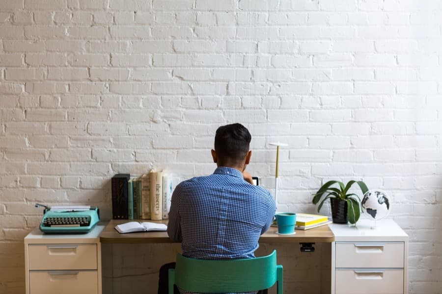 A person seated at a desk, facing away from the camera